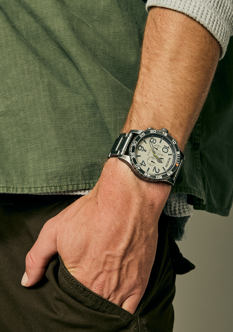 Man with his hands in his pockets while wearing a Nixon 51-30 Chrono analog watch