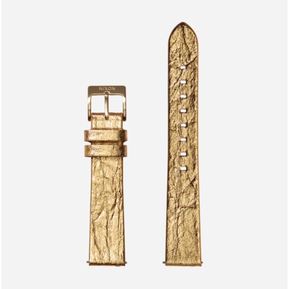 A sustainable gold Nixon watch band made from recycled or plant-based materials.